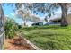 View of a spacious backyard with lush green grass and mature trees providing shade, perfect for outdoor activities at 9376 French Quarters Cir, Weeki Wachee, FL 34613