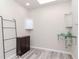 Well-organized bathroom with modern vanity, glass sink, storage cabinet, and decorative ladder at 9376 French Quarters Cir, Weeki Wachee, FL 34613