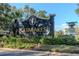 Elegant GlenLakes community entrance sign surrounded by lush landscaping and colorful flower beds at 9376 French Quarters Cir, Weeki Wachee, FL 34613