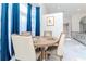 Bright dining area featuring a round table with seating and blue curtains for an elegant touch at 9376 French Quarters Cir, Weeki Wachee, FL 34613