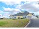 Stunning exterior view of a community clubhouse with beautifully landscaped grounds and blue skies at 9376 French Quarters Cir, Weeki Wachee, FL 34613