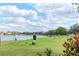 Scenic golf course view with lush green grass and serene lake, perfect for a relaxing day of golfing at 9376 French Quarters Cir, Weeki Wachee, FL 34613