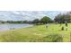 Beautiful golf course view with a golfer and a lake along the fairway on a sunny day at 9376 French Quarters Cir, Weeki Wachee, FL 34613