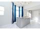 Bright kitchen with marble floors, granite countertops, stainless faucet and blue curtains at 9376 French Quarters Cir, Weeki Wachee, FL 34613