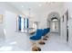 Bright kitchen with marble floors, granite countertops, blue barstools and modern lighting at 9376 French Quarters Cir, Weeki Wachee, FL 34613