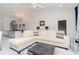 Spacious living room with a comfortable sectional sofa, stylish decor and a view into the kitchen at 9376 French Quarters Cir, Weeki Wachee, FL 34613