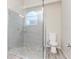 Modern bathroom with a glass-enclosed shower, pebble floor, and ample space at 9376 French Quarters Cir, Weeki Wachee, FL 34613