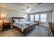 Serene bedroom with a ceiling fan, three windows, and a large wooden dresser at 9814 Palazzo St, Seffner, FL 33584