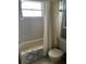 Bathroom with tub/shower combination features a white tile surround and neutral-toned fixtures at 9815 47Th N Ave # 303, St Petersburg, FL 33708