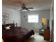 Bedroom with ceiling fan, side table with lamp, and natural light at 9815 47Th N Ave # 303, St Petersburg, FL 33708