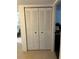 Image of a closet with shuttered doors in a room with beige tile floors at 9815 47Th N Ave # 303, St Petersburg, FL 33708