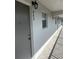 Hallway view showing unit number 303 outside the condo, with tile floor and outdoor lighting at 9815 47Th N Ave # 303, St Petersburg, FL 33708