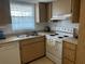 Kitchen with light wood cabinetry and stainless-steel sink showcases a window with natural light at 9815 47Th N Ave # 303, St Petersburg, FL 33708