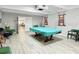 Bright recreation room featuring a billiard table and comfortable lounge seating at 9815 47Th N Ave # 303, St Petersburg, FL 33708