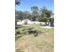 Large, grassy backyard featuring a partial fence and plenty of open space at 4905 Court St, Zephyrhills, FL 33541