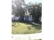 View of backyard and storage shed with white trim surrounded by lush landscaping at 4905 Court St, Zephyrhills, FL 33541