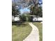 View of backyard with partial fencing, storage shed, and a concrete sidewalk at 4905 Court St, Zephyrhills, FL 33541