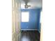 This bedroom features a ceiling fan, modern laminate flooring, and bright blue painted walls at 4905 Court St, Zephyrhills, FL 33541