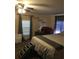 Bedroom with ceiling fan, neutral carpet and walls, and blue curtains at 4905 Court St, Zephyrhills, FL 33541