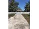Long driveway leading to a white picket fence and gate in the backyard at 4905 Court St, Zephyrhills, FL 33541
