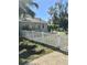 View of the side and back of the house with a white picket fence at 4905 Court St, Zephyrhills, FL 33541