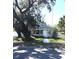Quaint home with mature trees, manicured lawn, picket fence, and inviting front entrance, showing charm and character at 4905 Court St, Zephyrhills, FL 33541