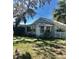 Charming home with a well-manicured lawn, flowers, and a picket fence at 4905 Court St, Zephyrhills, FL 33541