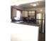 Functional kitchen with stainless steel appliances and bar seating, offering a modern and convenient cooking space at 4905 Court St, Zephyrhills, FL 33541