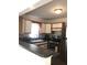 Functional kitchen featuring stainless steel appliances, wood cabinets, and dark countertops at 4905 Court St, Zephyrhills, FL 33541