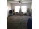 Spacious living room with carpeted flooring, natural lighting, and an inviting atmosphere, awaiting personal touches at 4905 Court St, Zephyrhills, FL 33541