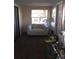 Sun-drenched room with an white chair, offering a cozy space with natural light and neutral decor at 4905 Court St, Zephyrhills, FL 33541