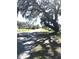 A neighborhood street view, shaded by a large tree with Spanish moss, showcases the community's peaceful setting at 4905 Court St, Zephyrhills, FL 33541
