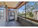 Screened balcony offering outdoor living with a view of the parking lot and mature tree at 10263 Gandy N Blvd # 2014, St Petersburg, FL 33702