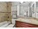 Bathroom with a granite countertop, tiled shower/tub, and updated fixtures at 10263 Gandy N Blvd # 2014, St Petersburg, FL 33702