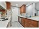 Kitchen features wood cabinets and appliances; open layout adjacent to living space at 10263 Gandy N Blvd # 2014, St Petersburg, FL 33702
