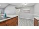 Bright kitchen features wood cabinets, stainless steel sink, and view to an adjoining room at 10263 Gandy N Blvd # 2014, St Petersburg, FL 33702