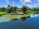 Scenic pond view featuring a community clubhouse, dock, and calm water, creating a serene atmosphere at 10263 Gandy N Blvd # 2014, St Petersburg, FL 33702