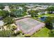 Aerial view of the community tennis courts surrounded by lush landscaping and a pond at 10263 Gandy N Blvd # 2014, St Petersburg, FL 33702