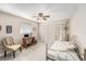 Guest bedroom featuring neutral paint, tile floors, and a ceiling fan at 11821 Boynton Ln, New Port Richey, FL 34654