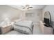 Neutral bedroom featuring tile floors, a ceiling fan, and a dresser with a mirror and a television at 11821 Boynton Ln, New Port Richey, FL 34654