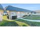 Inviting home exterior featuring a well-manicured lawn, gray metal roof, and charming landscaping at 11821 Boynton Ln, New Port Richey, FL 34654