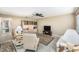 Bright living room with tile floors, neutral color palette, ceiling fan, and a display cabinet at 11821 Boynton Ln, New Port Richey, FL 34654