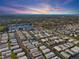 Beautiful aerial view of the vibrant community with a picturesque lake and colorful sunset backdrop at 12501 Ulmerton Rd # 34, Largo, FL 33774