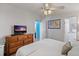 Bright bedroom with a large dresser and view into the bathroom at 12501 Ulmerton Rd # 34, Largo, FL 33774