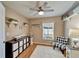 Cozy bedroom featuring decor shelving, a patterned chair, and a bright window at 12804 Raysbrook Dr, Riverview, FL 33569