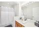 Bathroom featuring tub and shower, vanity, large mirror, and gray and white decor at 14532 Mirabelle Vista Cir, Tampa, FL 33626