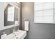 Modern powder room with sleek fixtures, a contemporary sink, and a large mirror at 14532 Mirabelle Vista Cir, Tampa, FL 33626