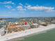 Expansive aerial view of beachfront condo with sandy beach, blue ocean, and beautiful intercoastal waterways at 14700 Gulf Blvd # 405, Madeira Beach, FL 33708
