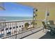 Relax on the condo balcony with gulf views, outdoor seating, and sunny skies at 14700 Gulf Blvd # 405, Madeira Beach, FL 33708