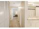 Bathroom featuring vanity and view to hall and bedroom with natural light at 14700 Gulf Blvd # 405, Madeira Beach, FL 33708